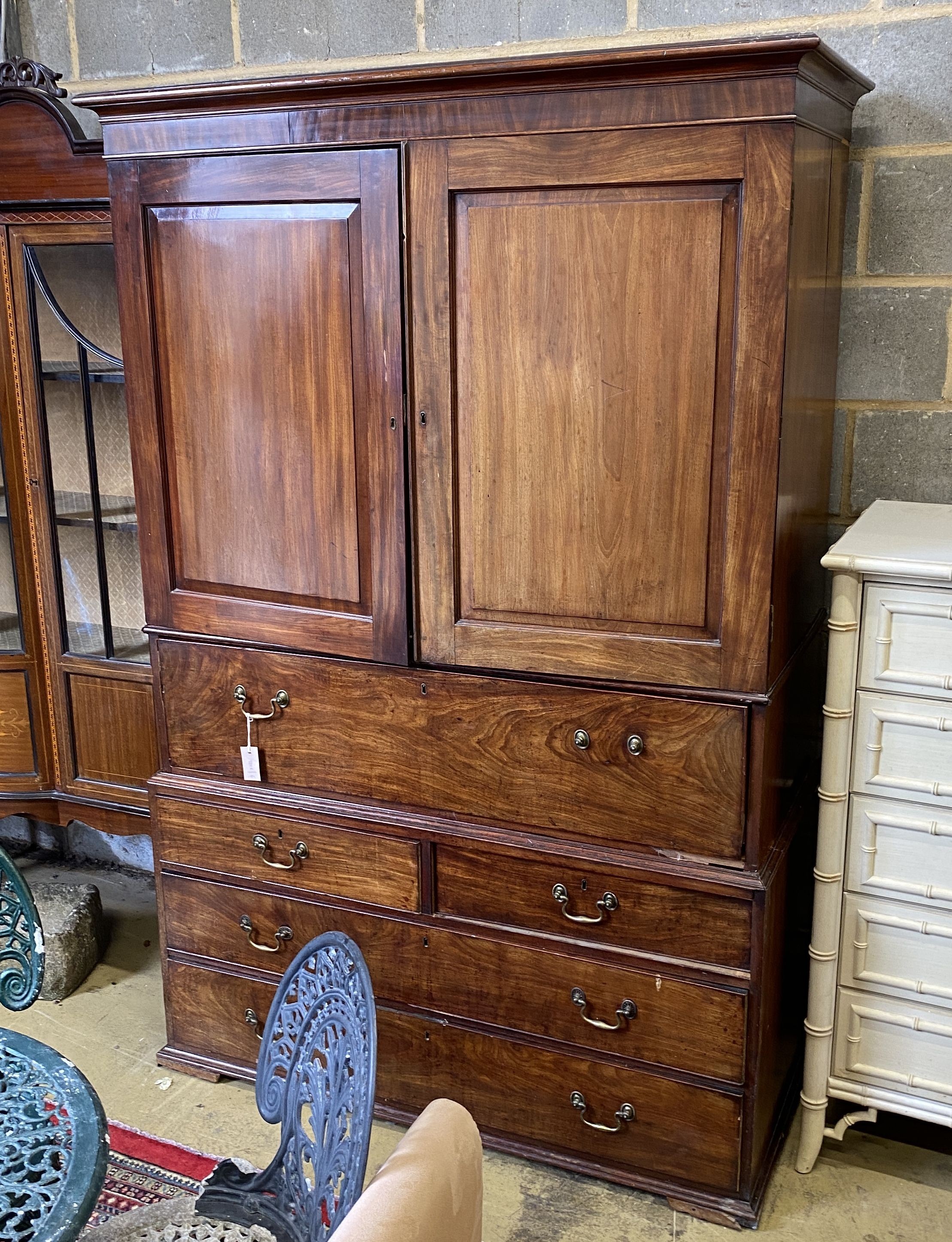 A George III mahogany secretaire linen press, width 130cm, depth 64cm, height 196cm